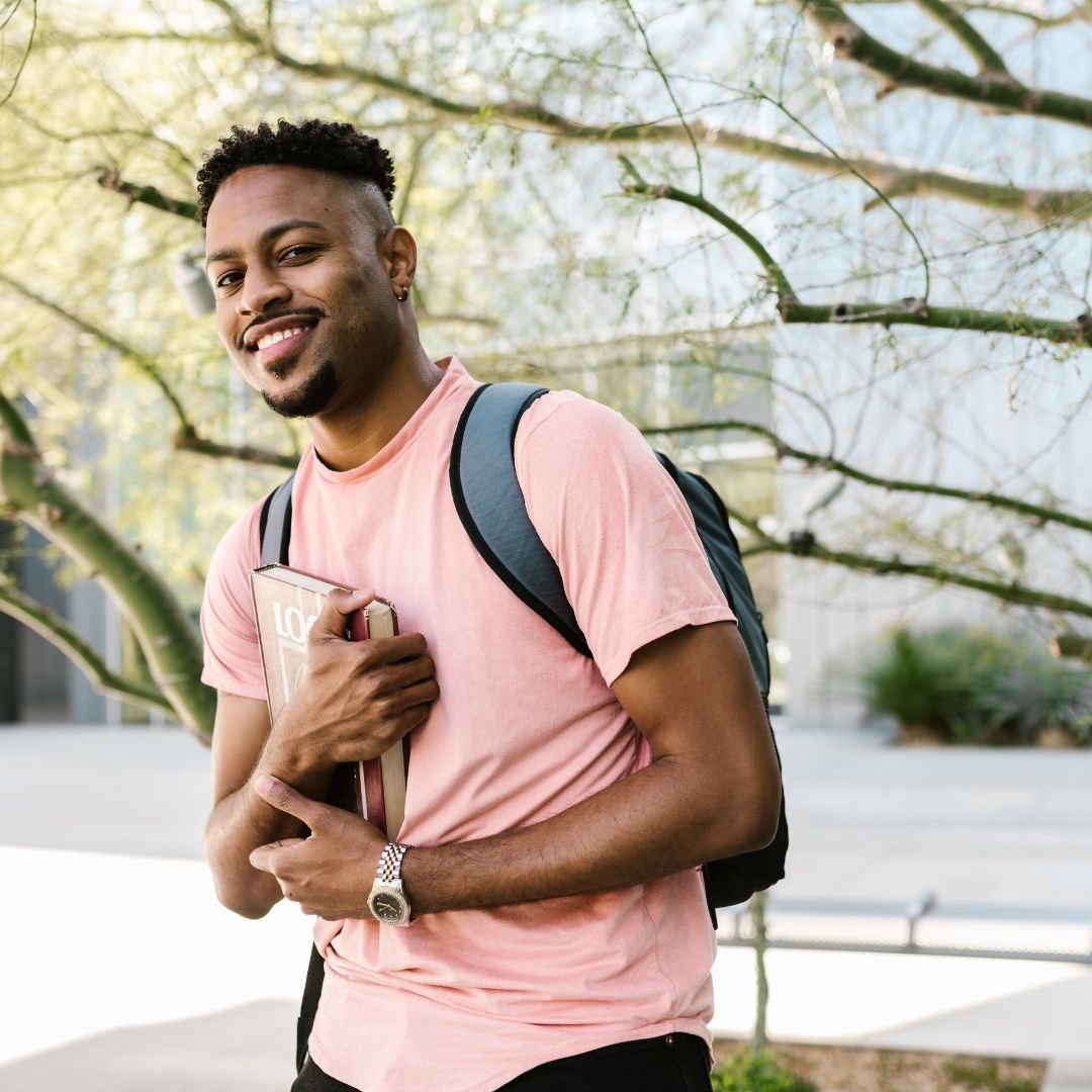 a young man walking to class